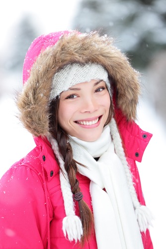 Girl wearing winter jacket outside in the snow