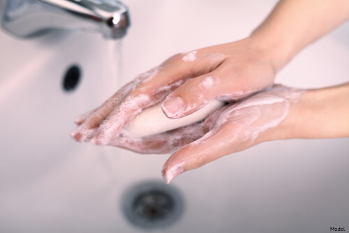 Person washing their hands with soap