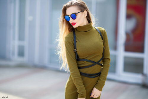 Woman wearing sunglasses and green outfit