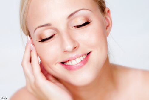 Woman touching her smooth face skin