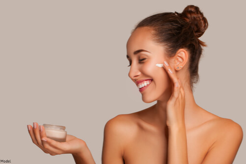 Woman putting out skincare cream