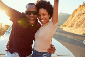 happy couple raising their hands