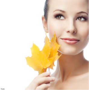 Woman holding a leaf to her face