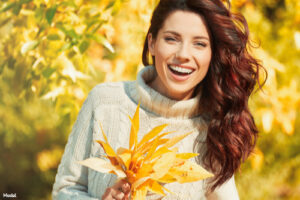 Woman smiling in a Fall setting