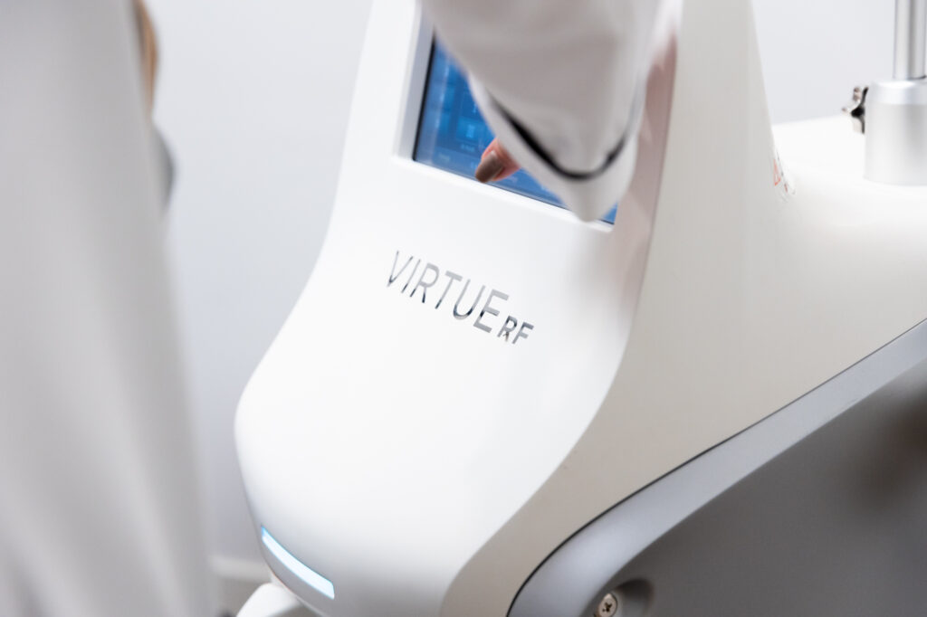 Provider adjusting settings for the Virtue RF device. This allows the provider to customize treatments for microneedling in Leesburg.